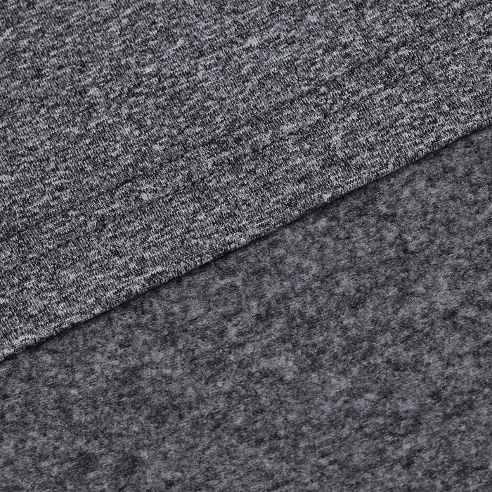 Close-up of two overlapping layers from the Heather Gray - Q-Zip: a smooth, moisture-wicking heathered gray knit on top and a soft, dark gray fleece beneath, showcasing the contrasting textures of each material.