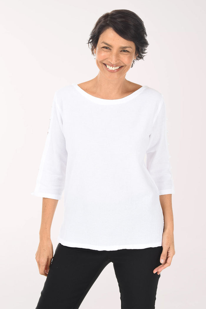 Woman wearing a white blouse and black pants on a white background