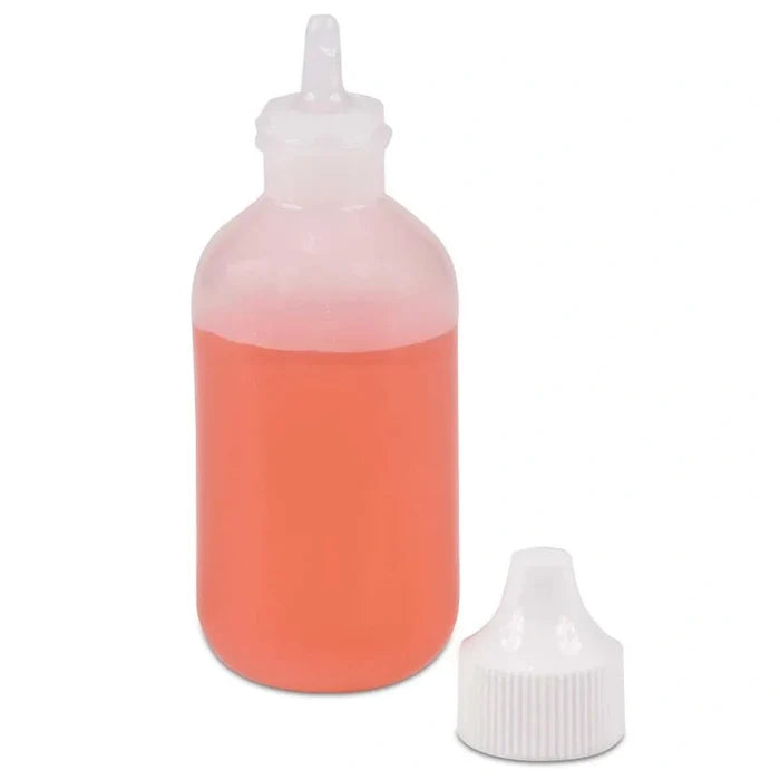 Bottle with red liquid and white cap on a white background