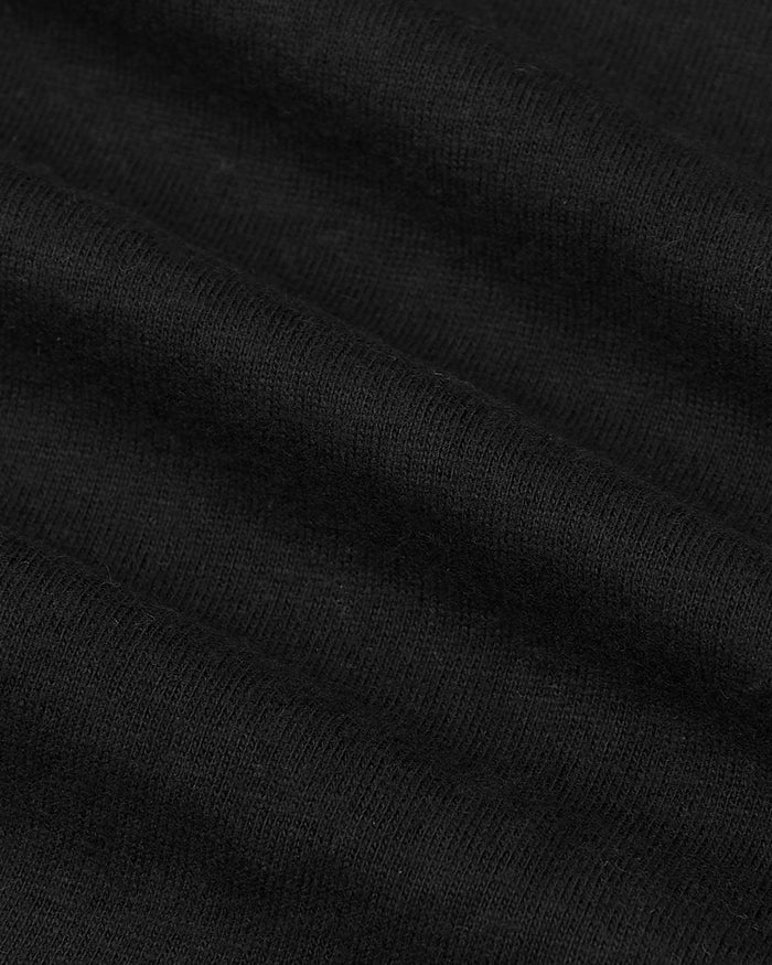 Black knit fabric close-up of the All Black Tall Classic Polo.