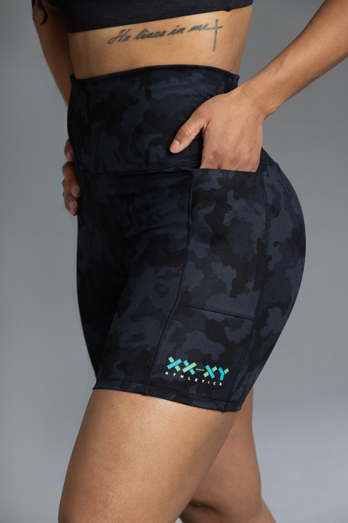 Black camouflage athletic shorts with a brand logo on a gray background || Black Camo
