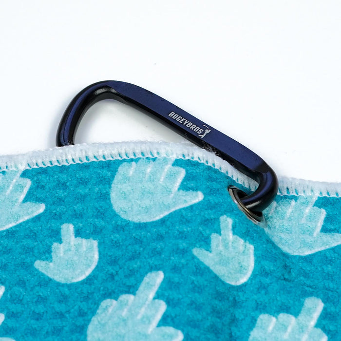 The Birdie Finger - Towel is a blue microfiber towel with white stitched edges and hand patterns showing a raised middle finger. It comes clipped to a sturdy black BOGEY BROS carabiner with an eyelet, displayed on a white background.