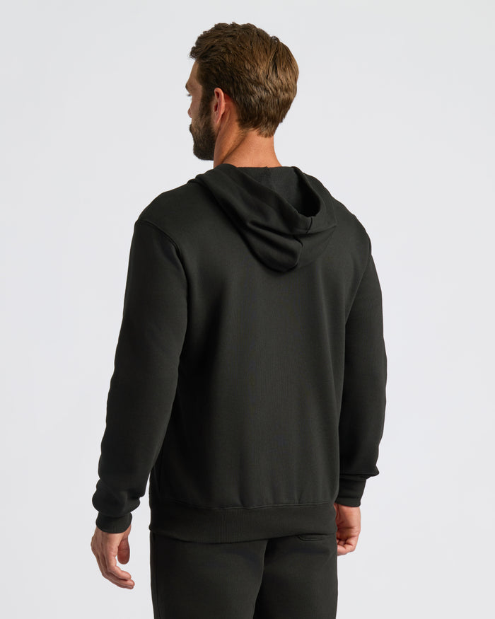 Black Fleece French Terry Zip Hoodie worn by a man, back view.