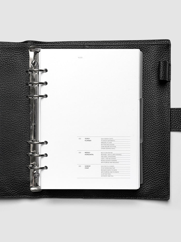 Blank, transparent side tab divider set shown in an A5 planner.