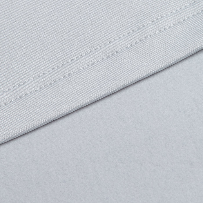 Close-up of the Bone Q-Zip’s light gray, athletic fit fabric with a smooth texture and neat stitching. Slight folds form a diagonal line, highlighting the Q-Zip’s moisture-wicking properties against a softly textured background.