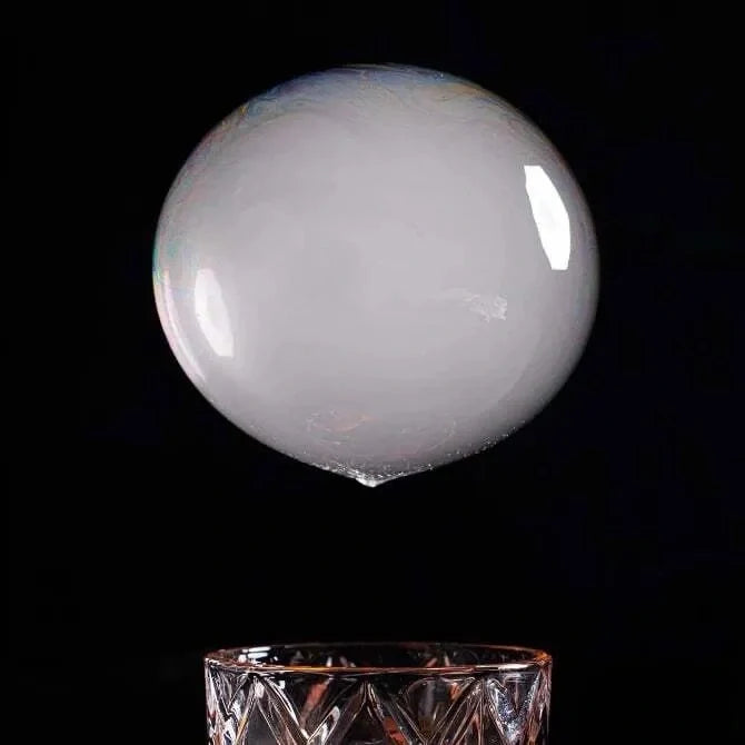 Clear smoke bubble on a black background.