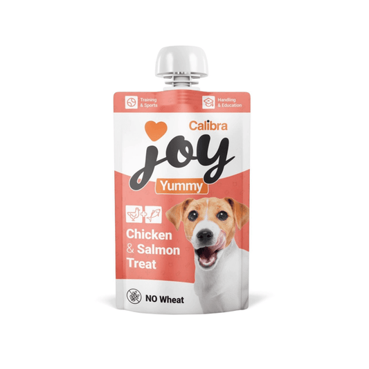White background with a white and pink pouch of Calibra Joy Yummy paste treat in Chicken and Salmon flavour.