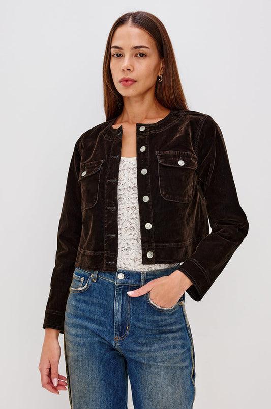 Capistrano Cropped Jacket in Chocolate Velvet Flocked Denim With Crew Neckline, Indigo Wash, Front Buttons, Buttoned Chest Pockets, and Long Sleeves in Chocolate Flocking Colorway - Upper Body Front View Featured on Model