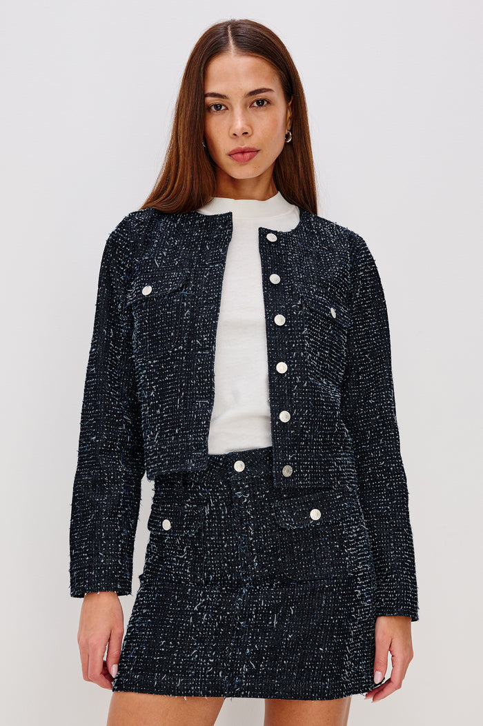 Capistrano Cropped Jacket in Denim Tweed Texture With Crew Neckline, Front Buttons, Buttoned Chest Pockets, and Long Sleeves in Denim Tweed Colorway - Upper Body Front View Featured on Model
