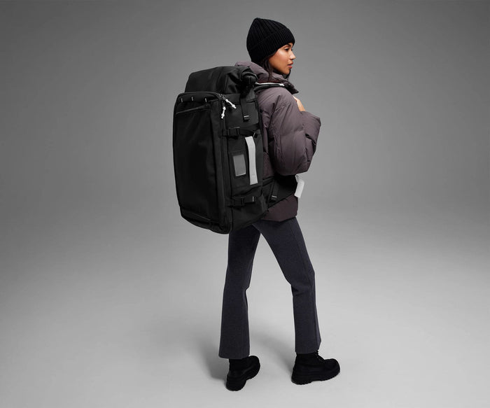 5'9" person wearing the 55L Boot Bag and winter clothes
// Model is 5’9”
