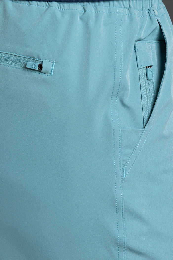 Close-up of light blue pants with a brand label on a matching background || Underseas