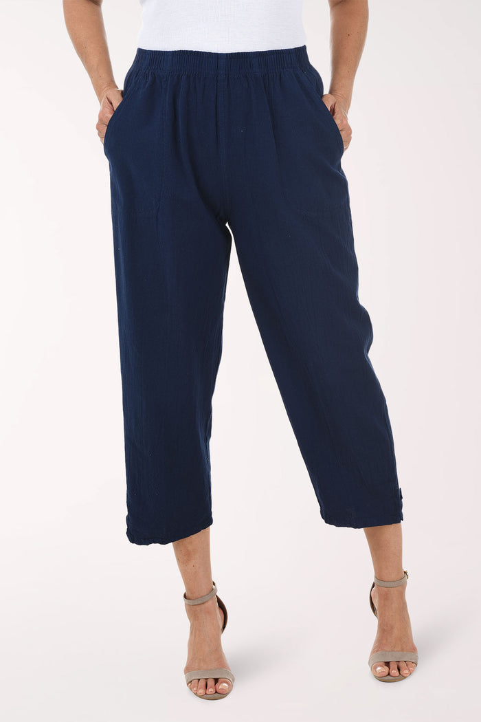Navy blue pants worn by a person on a white background