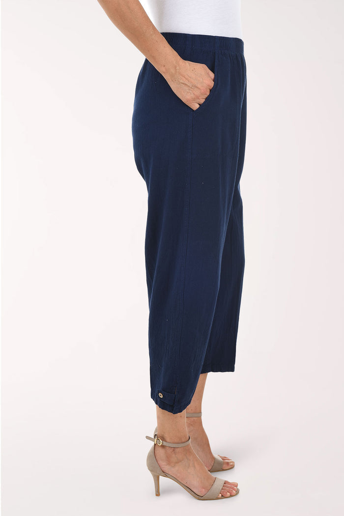Navy blue pants worn by a person on a white background