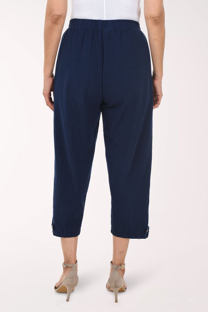 Navy blue pants worn by a person on a white background