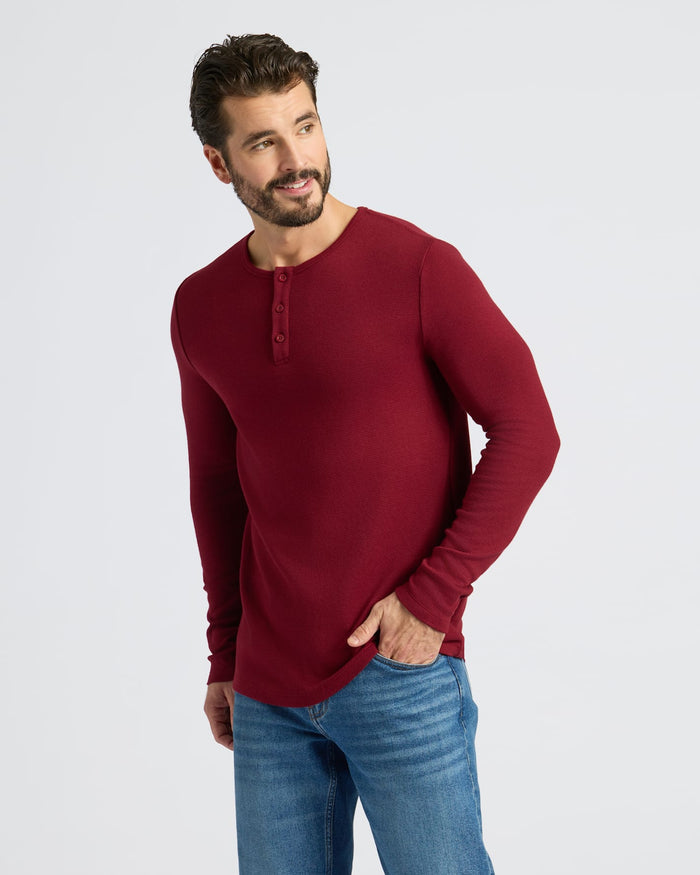 Man in Dark Maroon Waffle Long Sleeve Henley, medium-wash jeans.