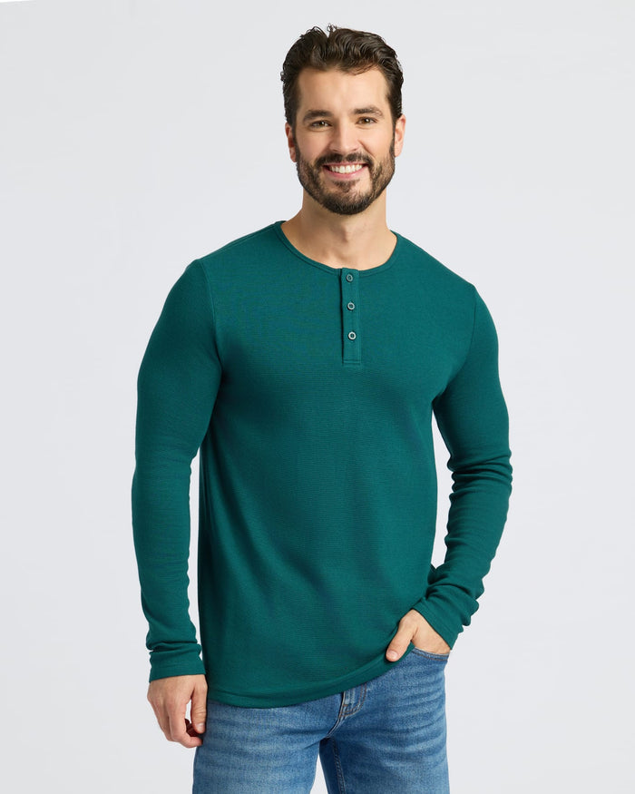 Man in Deep Emerald Waffle Long Sleeve Henley, hands in pocket.