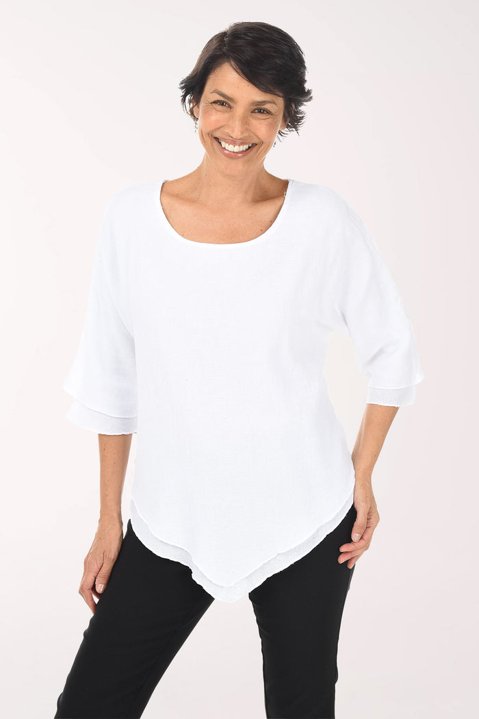 Woman wearing a white top and black pants on a white background