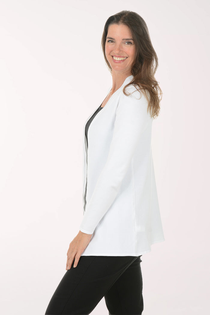 Woman wearing a white cardigan over a black top on a white background