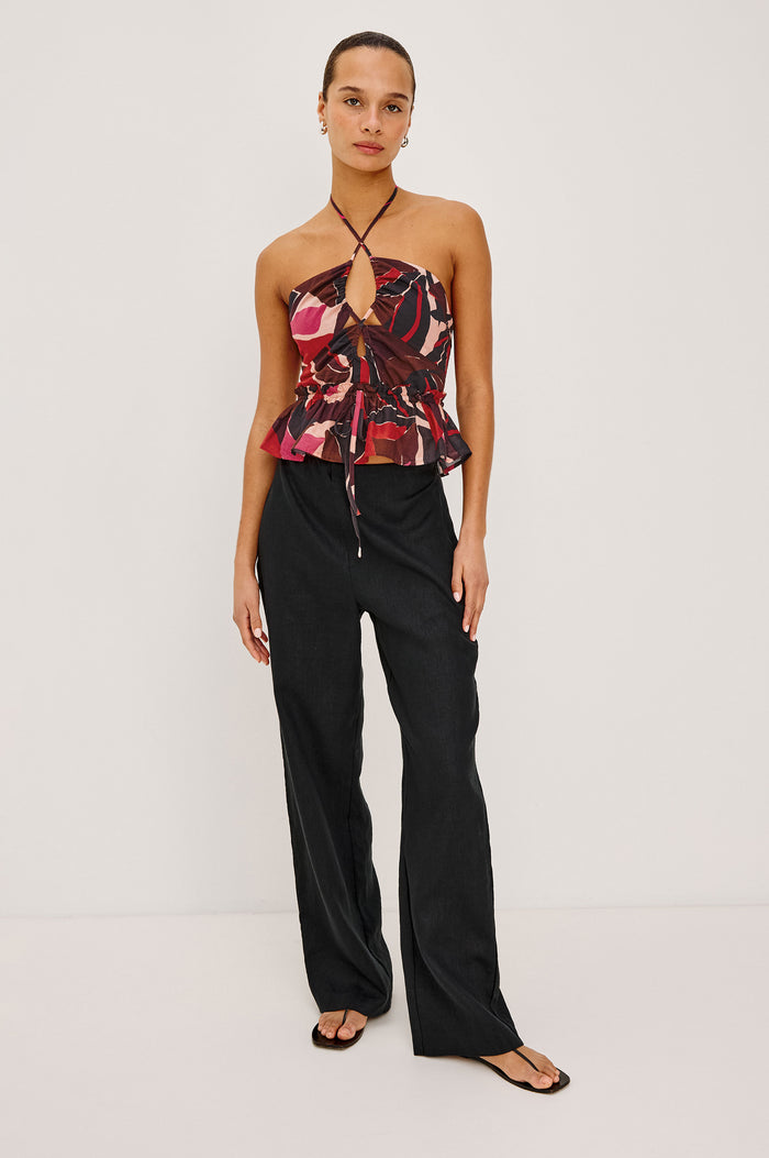 Dulce Cropped Tank Top in Cotton Voile With Abstract Print, Adjustable Halter Ties With Beaded Tassels, Front Keyhole Cutouts, Ruffle Trim and Hem, and Adjustable Front Self-Ties in Paradise Colorway - Front Full Body View Featured on Model