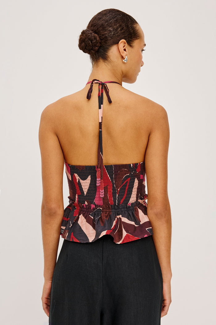 Dulce Cropped Tank Top in Cotton Voile With Abstract Print, Adjustable Halter Ties With Beaded Tassels, Front Keyhole Cutouts, Ruffle Trim and Hem, and Adjustable Front Self-Ties in Paradise Colorway - Upper Body Back View Featured on Model