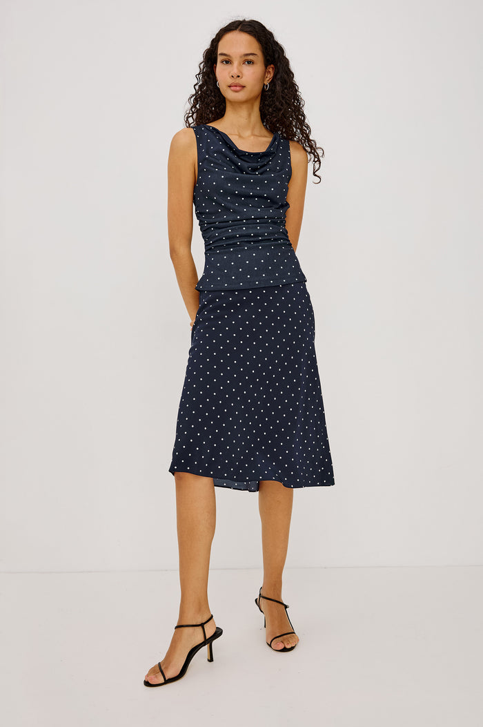 Fete Fitted Top in Stretch Mesh With Cowl Neck, Side Ruching, Front Lining, and Fitted Design in Navy Polka Dots Colorway - Full Body Front View Featured on Model