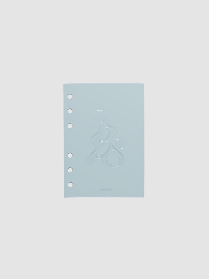 Light blue, semi-transparent, and glossy plastic planner dashboard with organic raised shape design in size A6 on a neutral background.