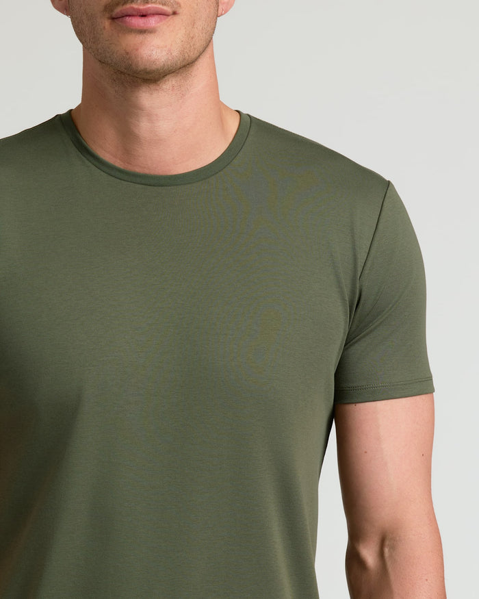Close-up of a man wearing an olive green Grove Tall Pima Cotton Blend Curved Hem Crew shirt, showcasing a smooth, comfortable fabric ideal for men's basics.