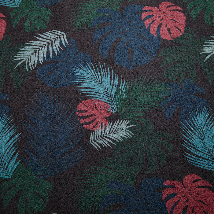 Haolie Nights - Towel features a two-sided print inspired by microfiber towel patterns, showcasing large green, blue, and teal tropical leaves with pink split-leaf monstera on a dark background for a rich, layered jungle effect.
