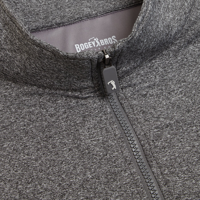 Close-up of the Heather Gray - Q-Zip, an athletic-fit jacket featuring a centrally placed zipper with a golf club logo pull tab. BOGEY BROS is printed in white on the gray inner collar lining.