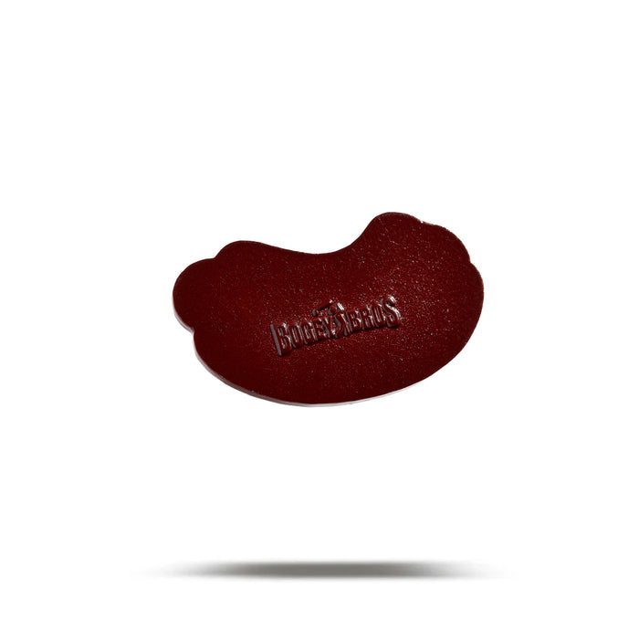 A single hot dog-shaped ball marker with a smooth, shiny surface sits centered on a white background. The word HOT DOG is embossed in uppercase letters with an iron/nickel finish. A soft shadow appears below it.