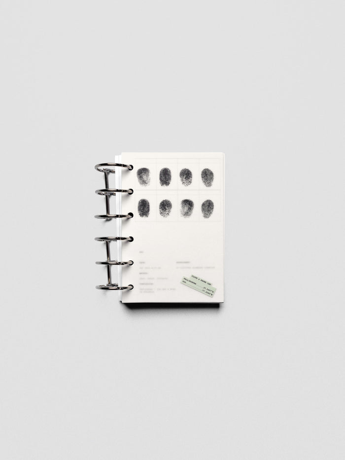 Two layered Pocket sized planner dashboards, one semi-transparent, one matte, featuring a fingerprint design shown in a ring bound planner.