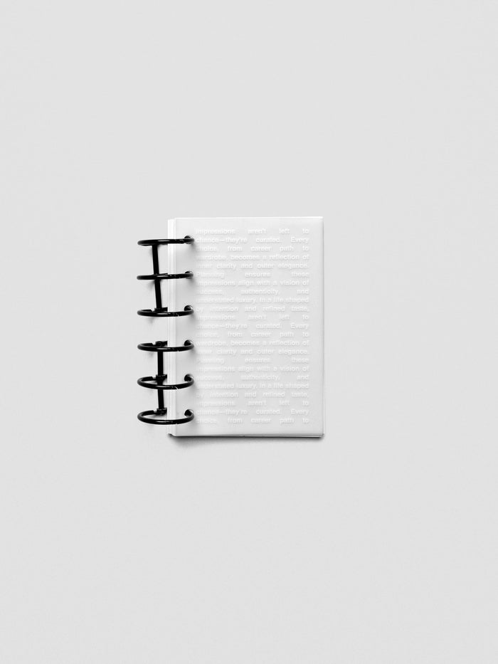 Pocket-size Impressions Dashboard shown in a planner with translucent layering.