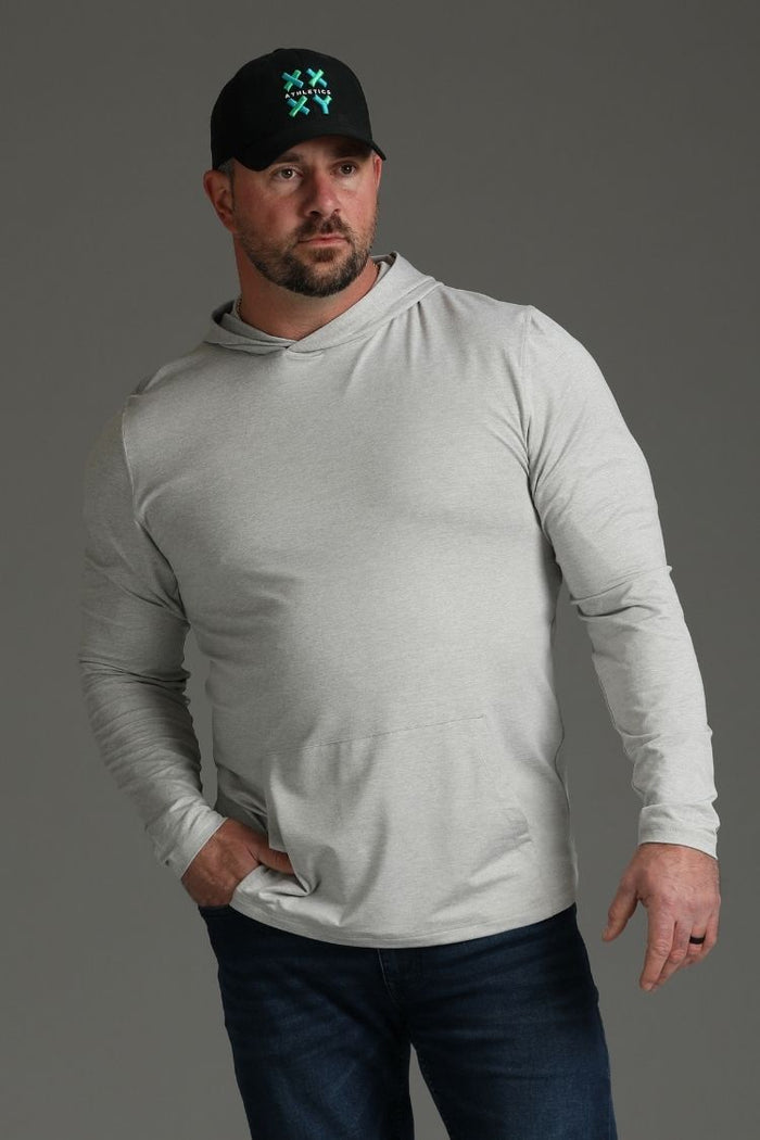 Man wearing a gray long-sleeve shirt and black cap with a logo on a gray background || light heather gray - 1