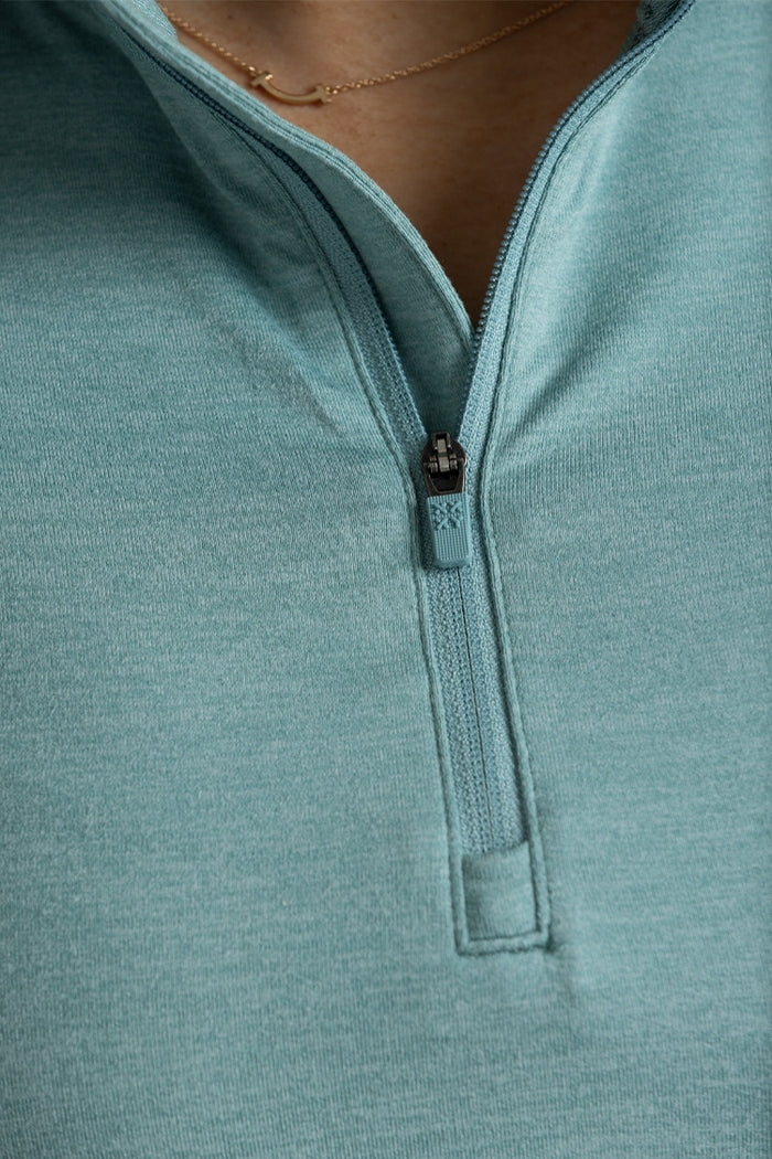 Close-up of a teal pullover with a zipper detail || Underseas