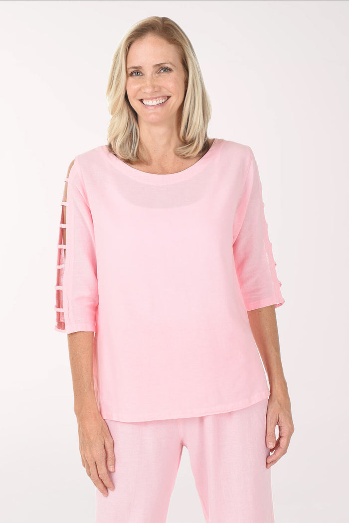 Woman wearing a pink blouse and pants on a white background