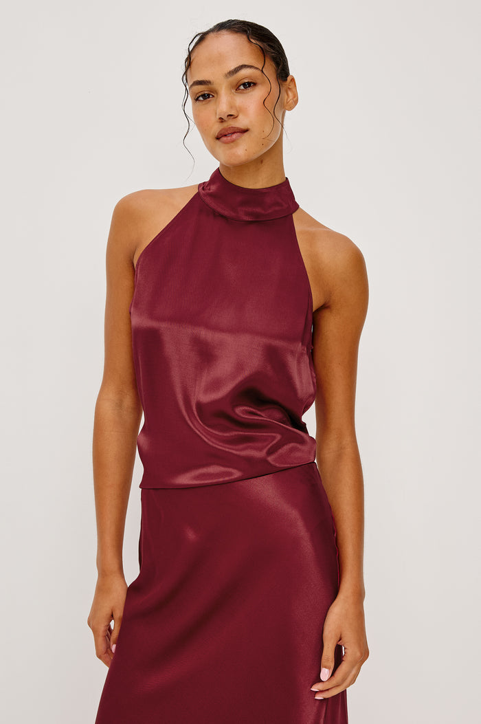 Leah Halter Top in Satin Crepe With a High Neckline, Sleevleless Cut, Back Button Neck Closure in Garnet Colorway - Upper Body Front View Featured on Model