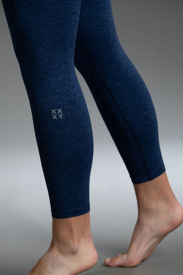 Navy blue leggings with a small logo on a gray background || Navy