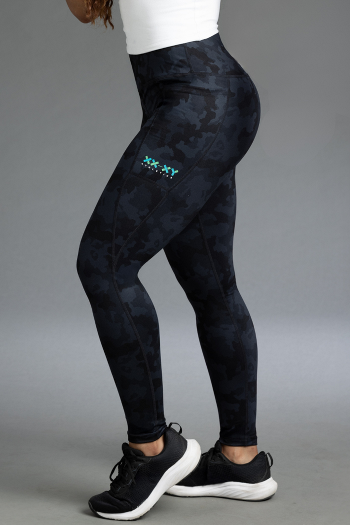 Black patterned leggings with a brand logo on a gray background || Black Camo