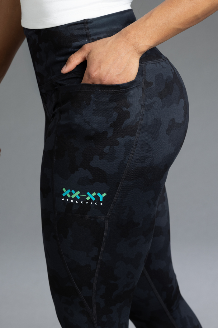 Black camouflage pants with a brand logo on a gray background || Black Camo