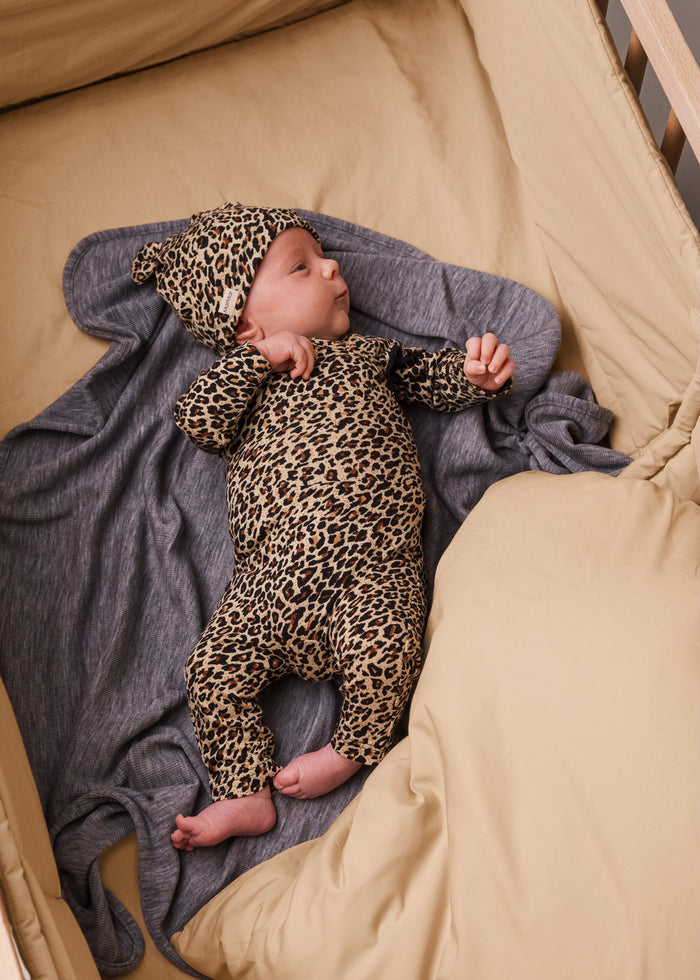Baby in leopard jumpsuit and hat