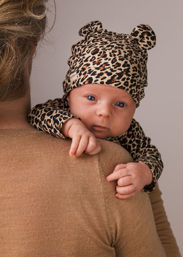 Baby in leopard printed hat with ears