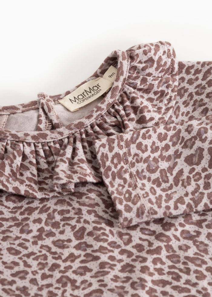 Baby bodystocking with leopard print in dusty purple, ruffled collar, and tag on the neck.