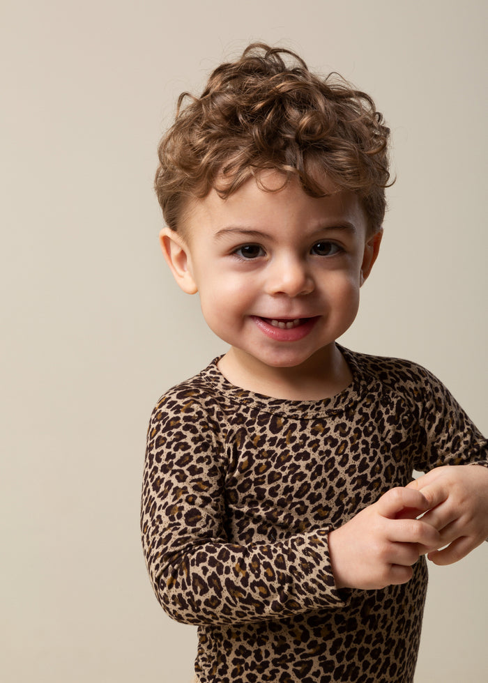 Boy in leopard print bodysuit