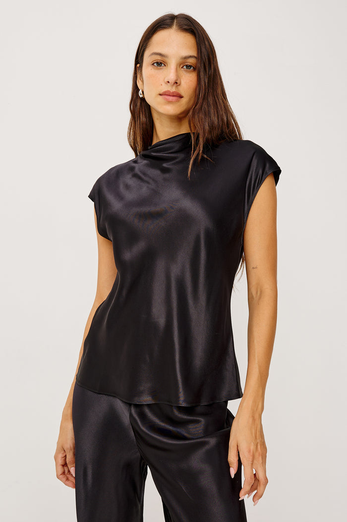 Loretta Top in Satin Back Crepe With a Loose Fit, Cowl Neckline, Cap Sleeves, and a Back Keyhole Button Cutout in Black Colorway - Upper Body Front View Featured on Model