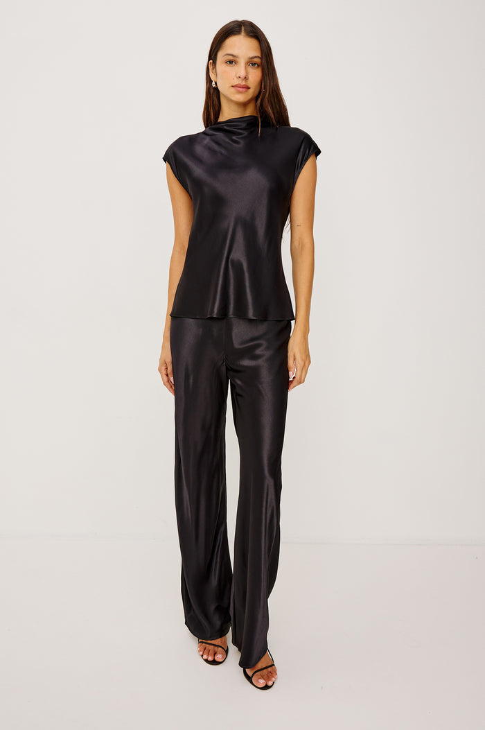 Loretta Top in Satin Back Crepe With a Loose Fit, Cowl Neckline, Cap Sleeves, and a Back Keyhole Button Cutout in Black Colorway - Full Body Front View Featured on Model