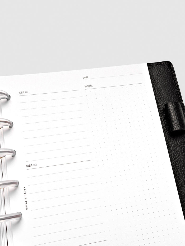 Close up of Mental Download inserts inside discbound planner and leather cover.
