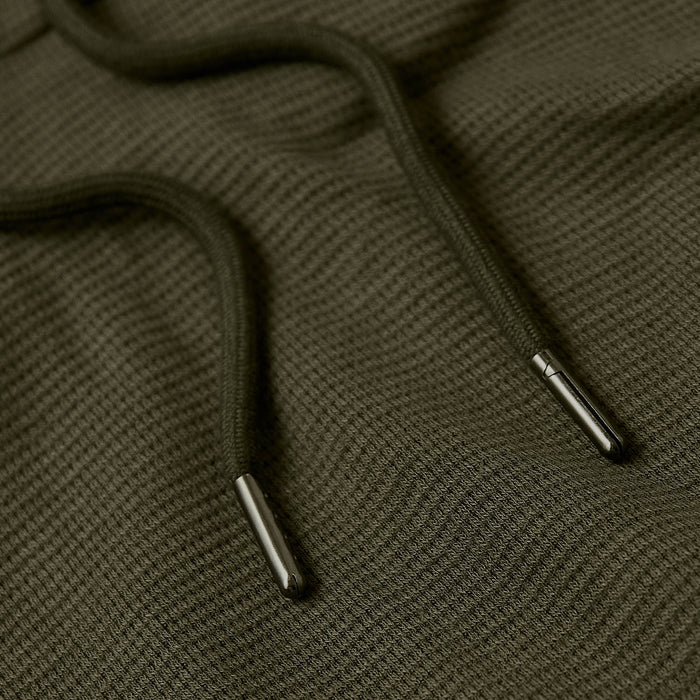 Military Green Waffle Hoodie draw-strings on waffle-knit fabric.