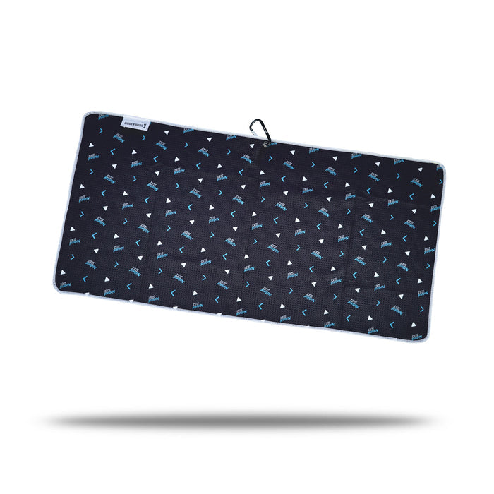 The Natural Slice - Towel is a rectangular black microfiber towel with a subtle grid pattern, scattered light-blue and white shapes, white-trimmed edge, loop with clip and eyelet fastener, floating above a shadow.