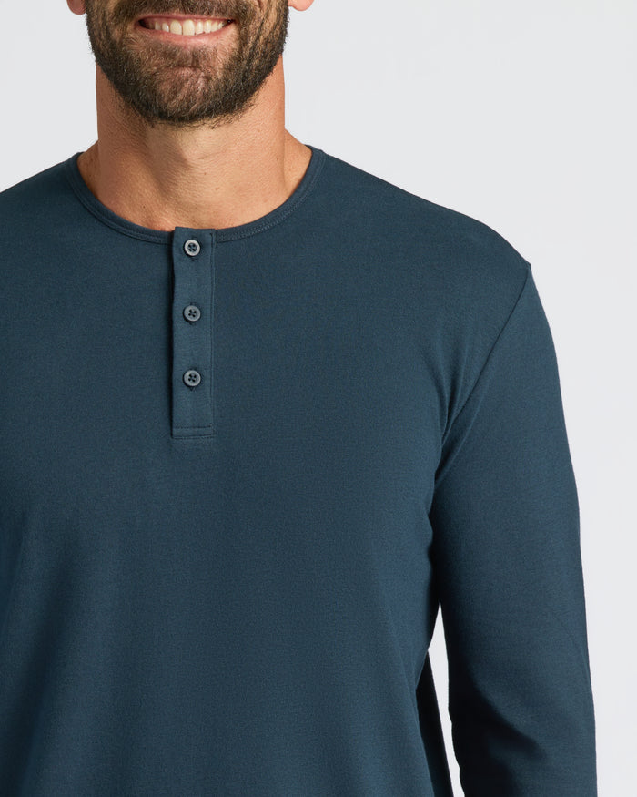 Man in Navy Classic Long Sleeve Henley, smiling against a light background.