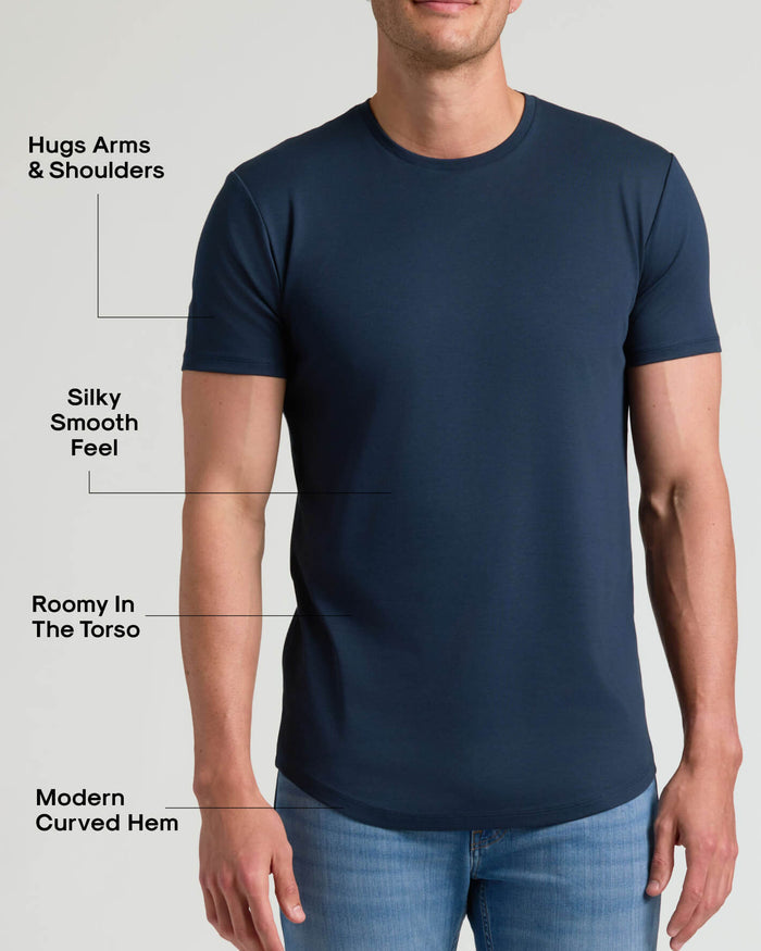 Man wearing a navy crew neck t-shirt with a modern curved hem that hugs arms and shoulders, has a silky smooth feel, and offers a roomy fit in the torso, Tall Pima Cotton Blend Curved Hem Crew 4-Pack.